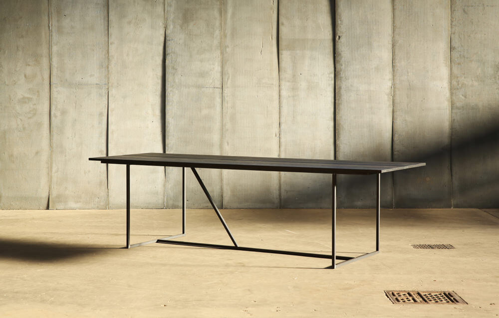 Mesa Nero – a table in distressed French oak by Heerenhuis