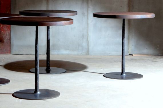 Spike tables with reclaimed teak top over metal base – made to measure by Heerenhuis
