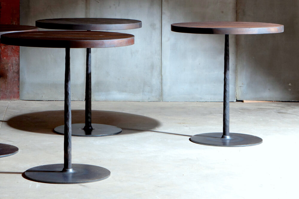 Spike tables with reclaimed teak top over metal base - made to measure by Heerenhuis