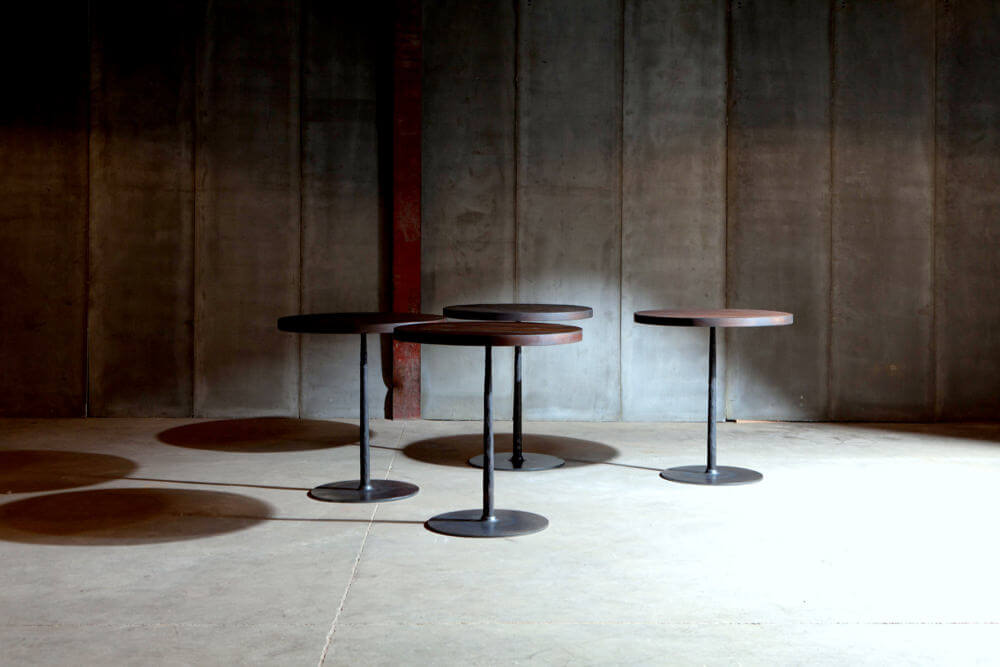 Spike tables with reclaimed teak top over metal base - made to measure by Heerenhuis